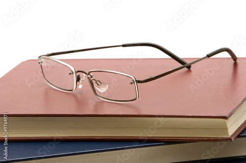 Eyeglasses on a stack of books