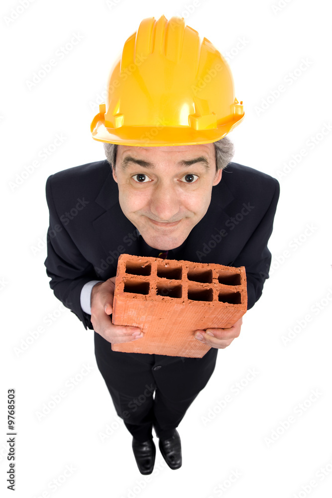 mature worker holding a brick, isolated on white mature worker holding a brick, isolated on white