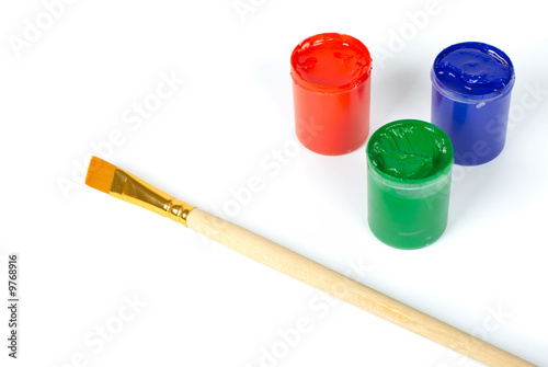Red blue and green paints and brush