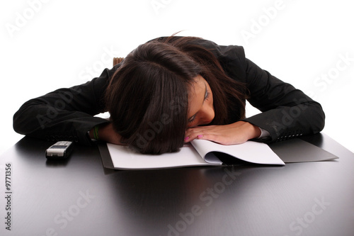 young business woman sleeping on the desk, isolated in white