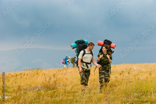 Backpackers hike in mountains