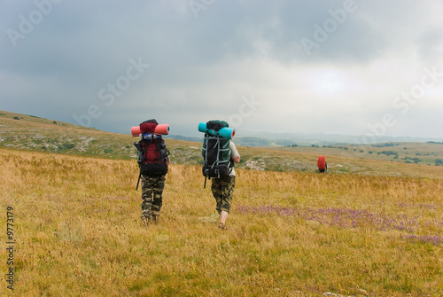 Backpackers hike in mountains © Anton Gvozdikov