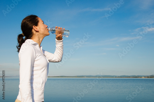 Drinking Woman with a blue sky outside
