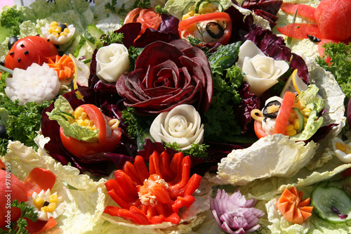 Salad decorated with flowers made of vegetables