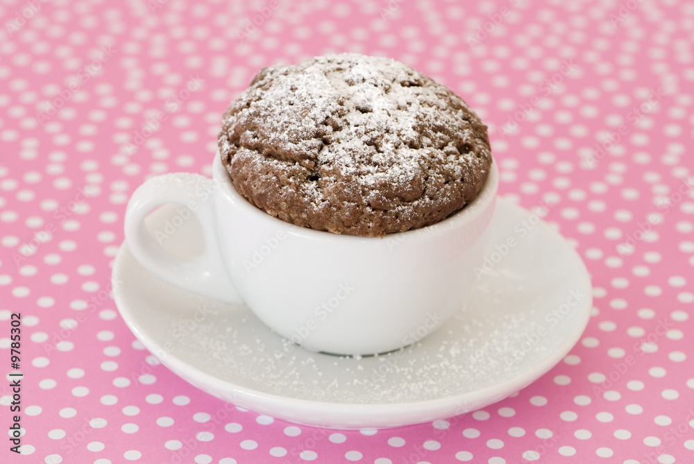 Dusted cupcake on pink polka dot background Dusted cupcake on pink polka dot background