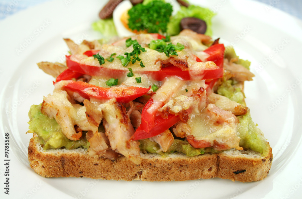 Grilled open chicken sandwich with avocado and cheese