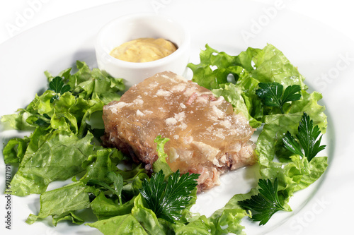 Meat Jelly Served with Salad Leaves and Sour Cucumber Cream