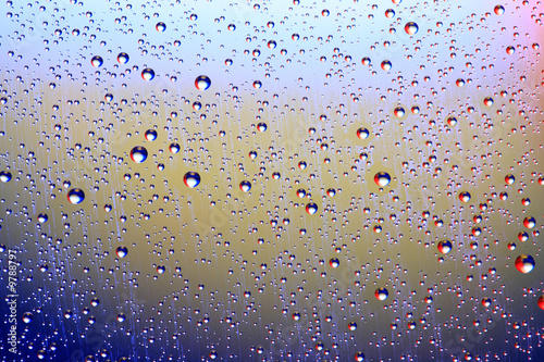 Drops of water on a blue  lila background.
