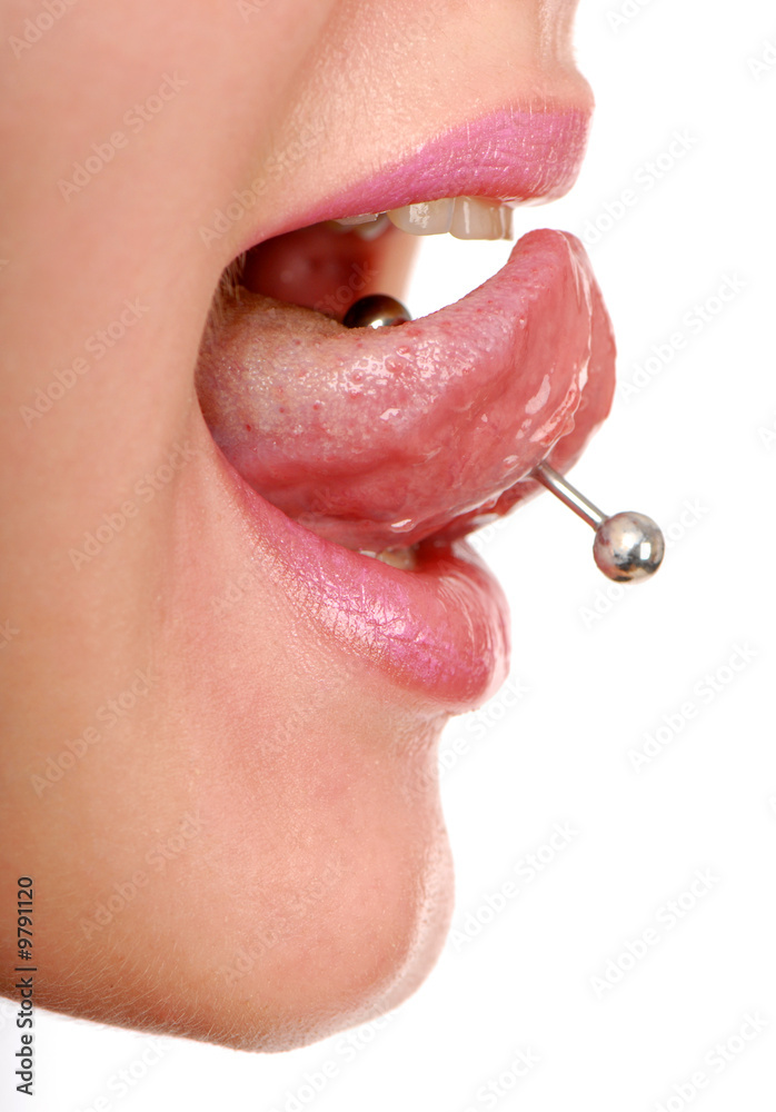 Fototapeta premium woman sticking out her tongue to show piercing