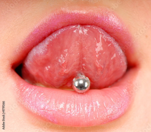 woman sticking out her tongue to show piercing