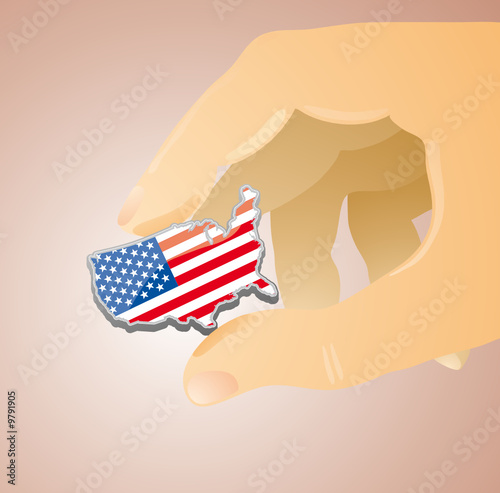 USA placard shape between two fingers of a giant hand. photo