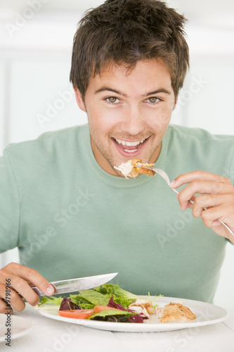 Young Man Enjoying Healthy meal,mealtime photo