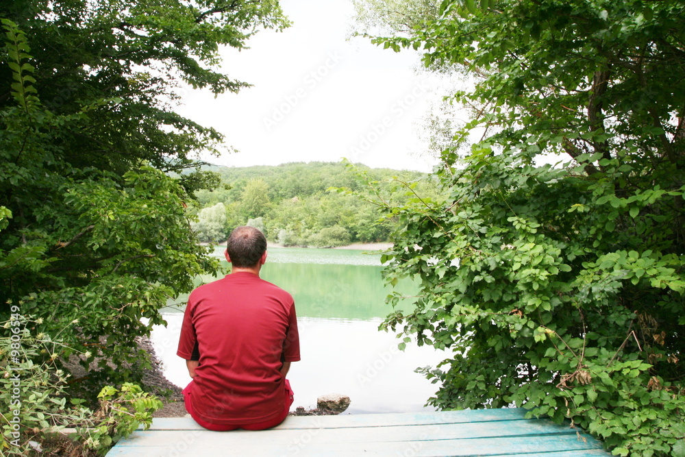 Fototapeta premium Men relaxing on lake