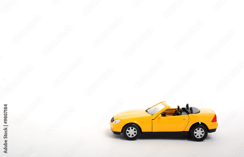 A yellow toy car on white background