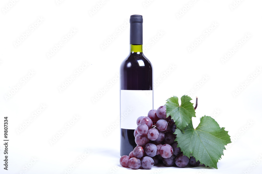 Close up of a bottle of wine and grapes