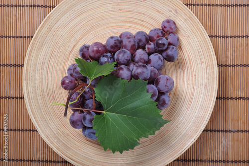Cluster of grapes on wooden...