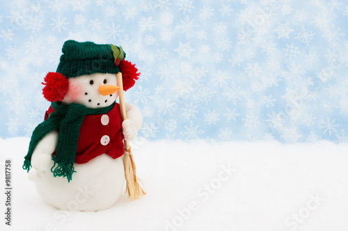 Snowman on snow with snowflake background