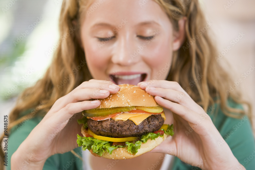 Teenage Girl Eating Burgers
