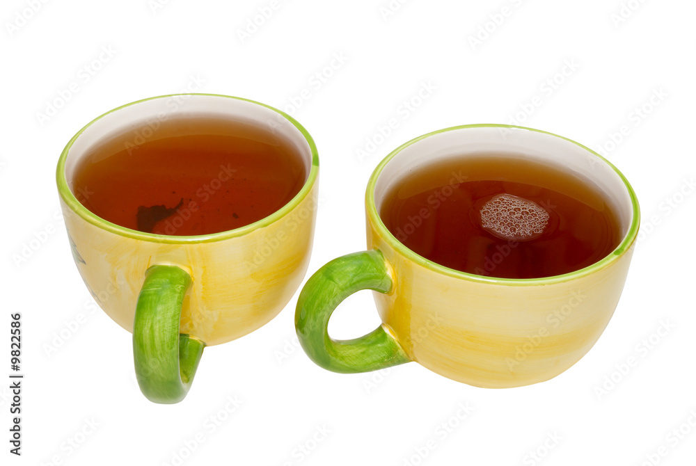 Two teacups with tea isolated on white. Two teacups with tea isolated on white.