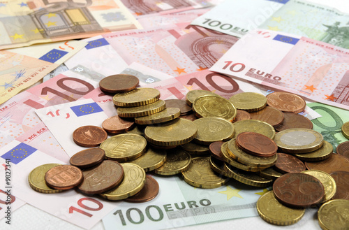 Euro coins falling on euro banknotes, isolated