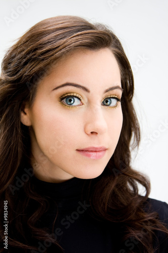 Face of a beautiful blue eyed brunette, isolated