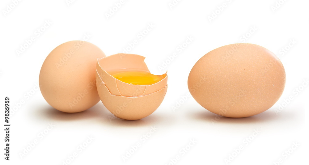 Two whole and one broken raw egg on white Two whole and one broken raw egg on white