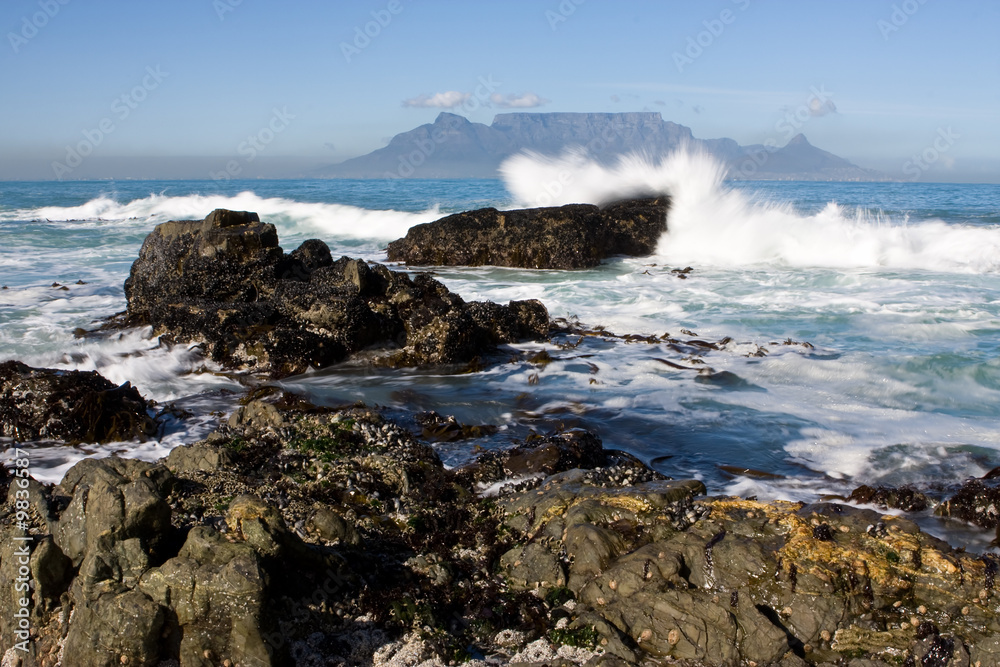Table Mountain from Bloubergstrand with rocks in the foreground