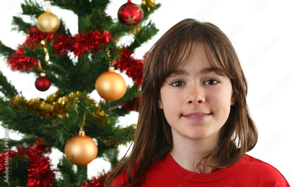 Christmas time - girl decorating Christmas tree Christmas time - girl decorating Christmas tree