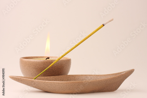 Candle and incense stick in pastel shades photo
