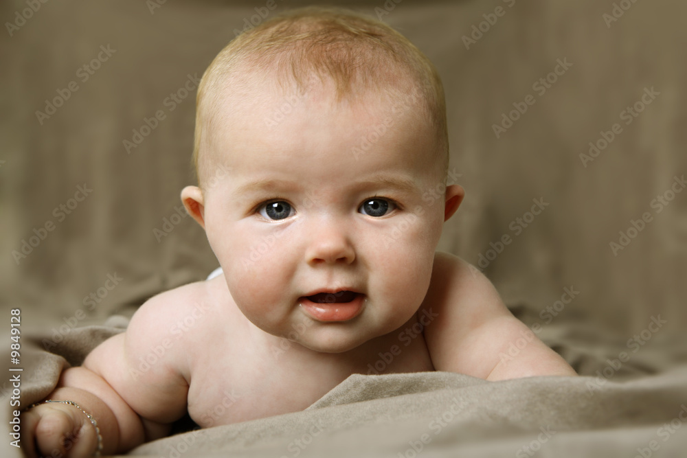 Beautiful little baby girl looking at the camera. Beautiful little baby girl looking at the camera.