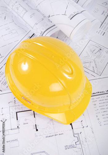 Building plans and yellow hardhat