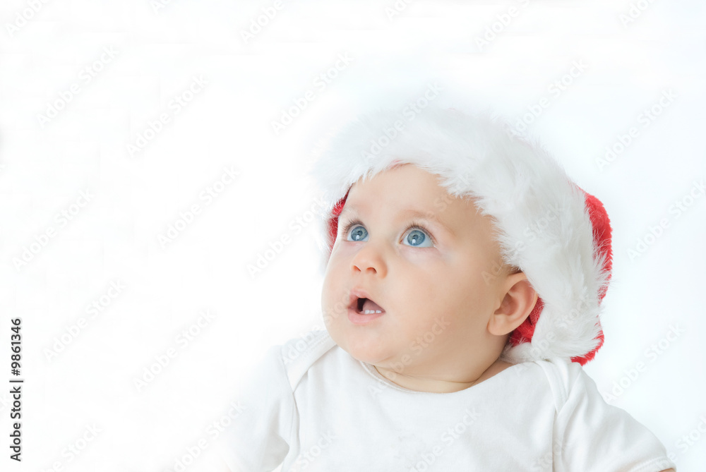 little, cute baby boy wearing Christmas hat, on white little, cute baby boy wearing Christmas hat, on white