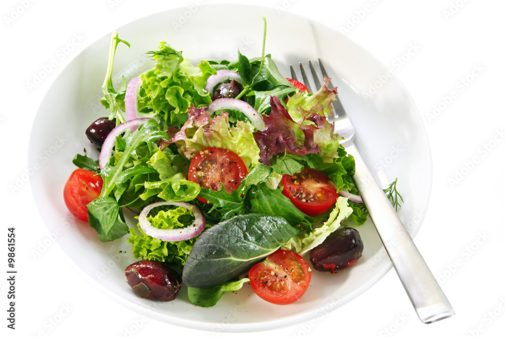 Simple garden salad in a white bowl with fork.