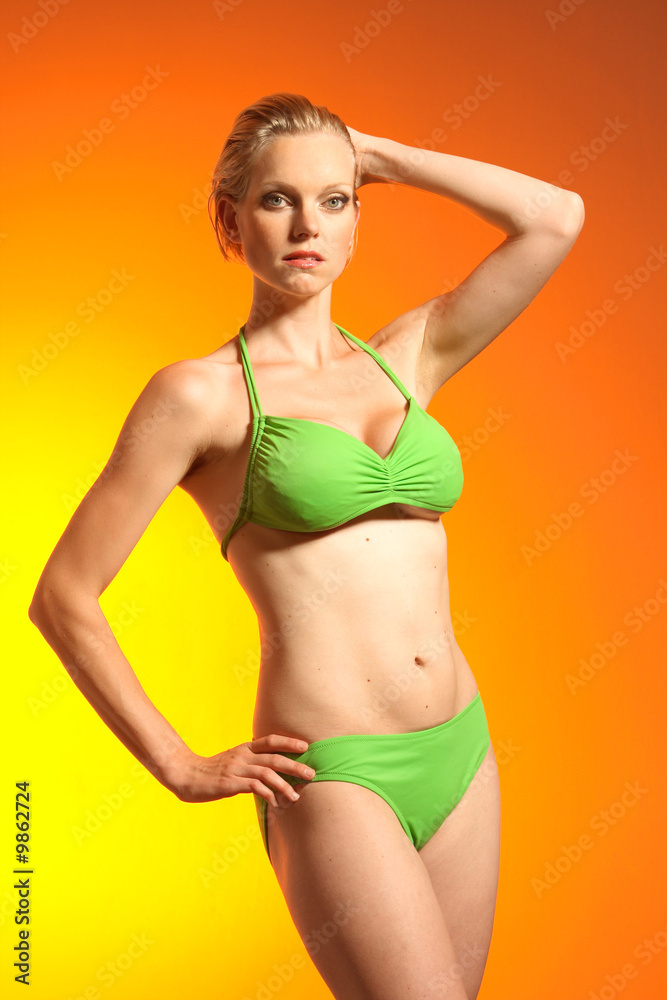 Model posing in a green bikini