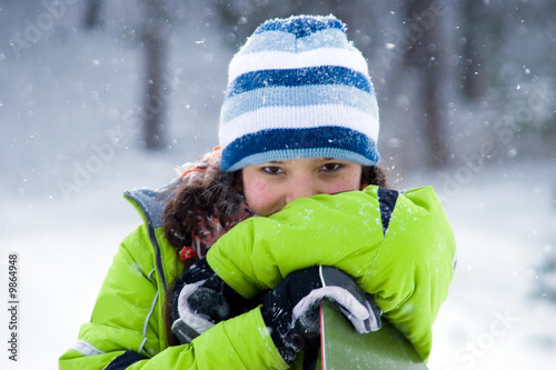 Laughing beautiful girl snowboarder, snowfall