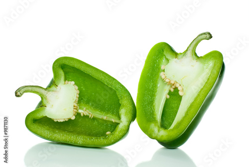 Two halves of green sweet pepper isolated on the white