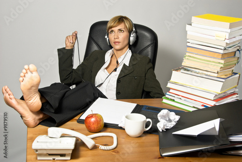 Obraz na plátně Lazy Businesswoman or Student with headphones