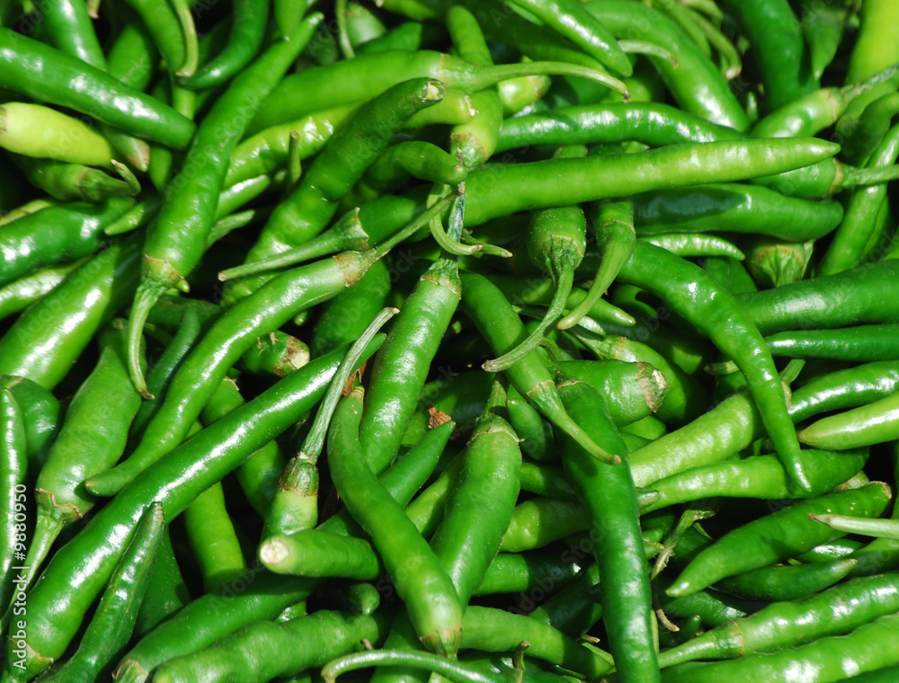 Close-up of green chili peppers on market stall