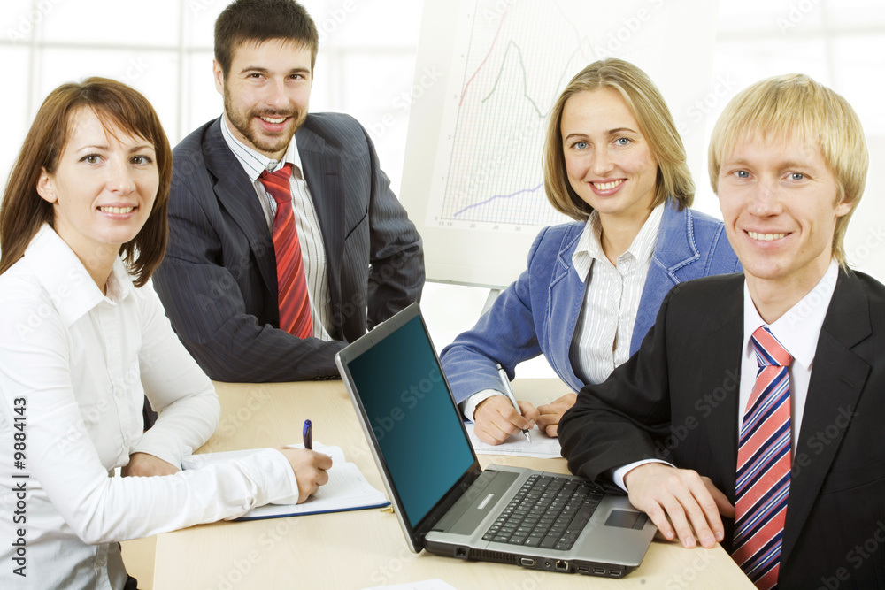 Four professionals looking at camera during briefing