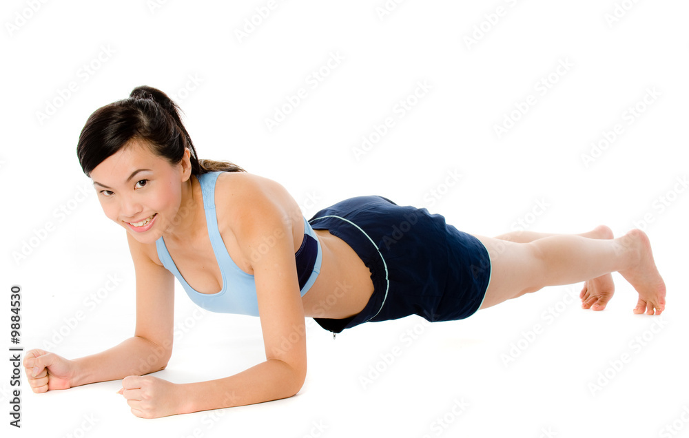 A young attractive Asian woman doing a plank pose A young attractive Asian woman doing a plank pose