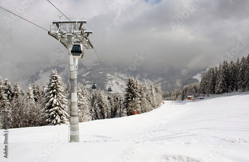 Alpine skilift in snowy Swiss alps mountains scene