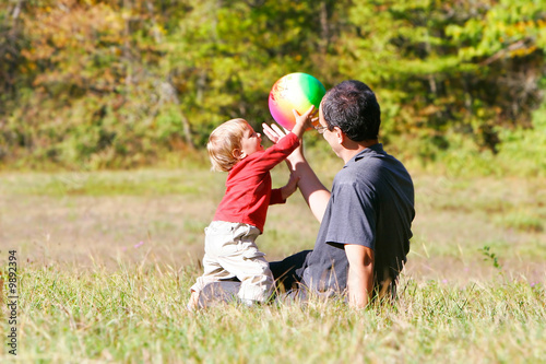 father playing with son outdoors