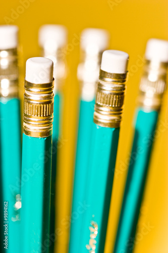 Fotografie stationery series: pencils with eraser over yellow background