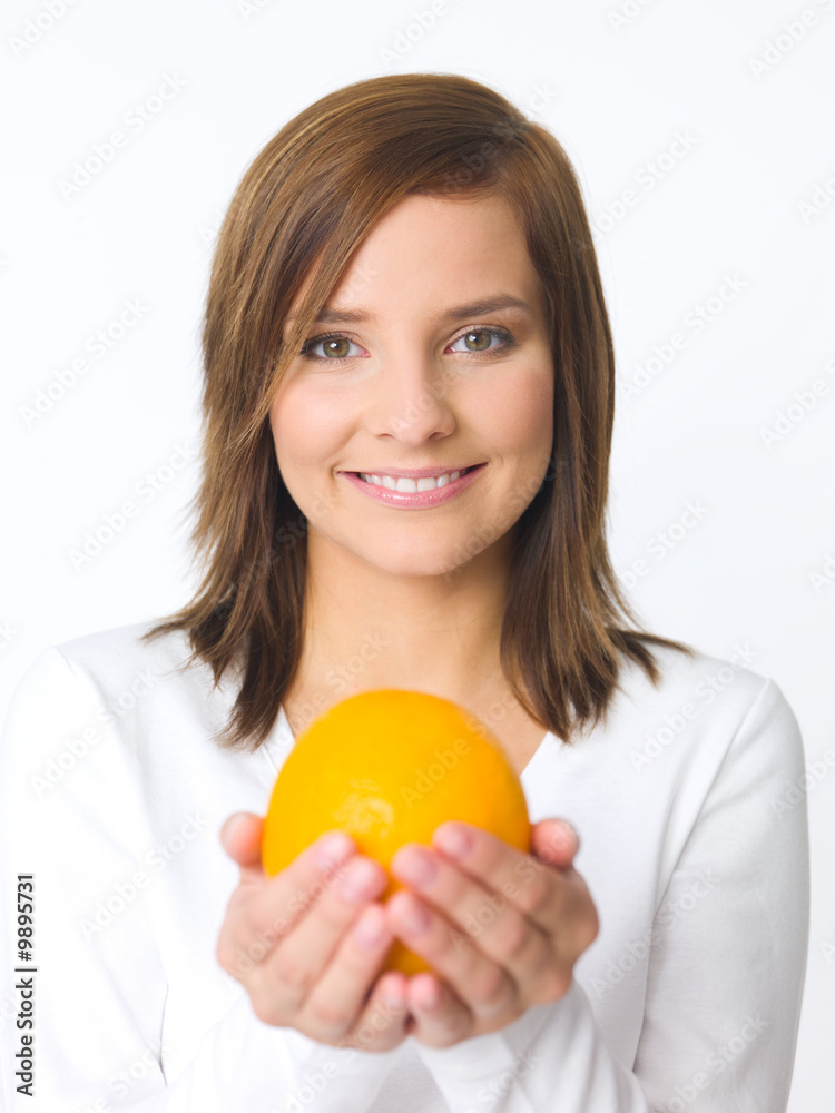 Portrait of beautiful young woman holding fresh orange fruit Portrait of beautiful young woman holding fresh orange fruit