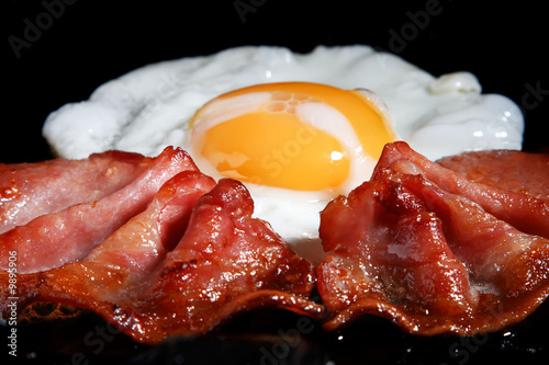 frying egg and two bacon rashers, shallow DOF