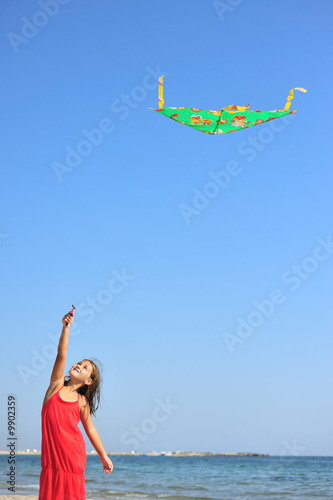 Little girl flying a kite on the beach © Orlando Florin Rosu
