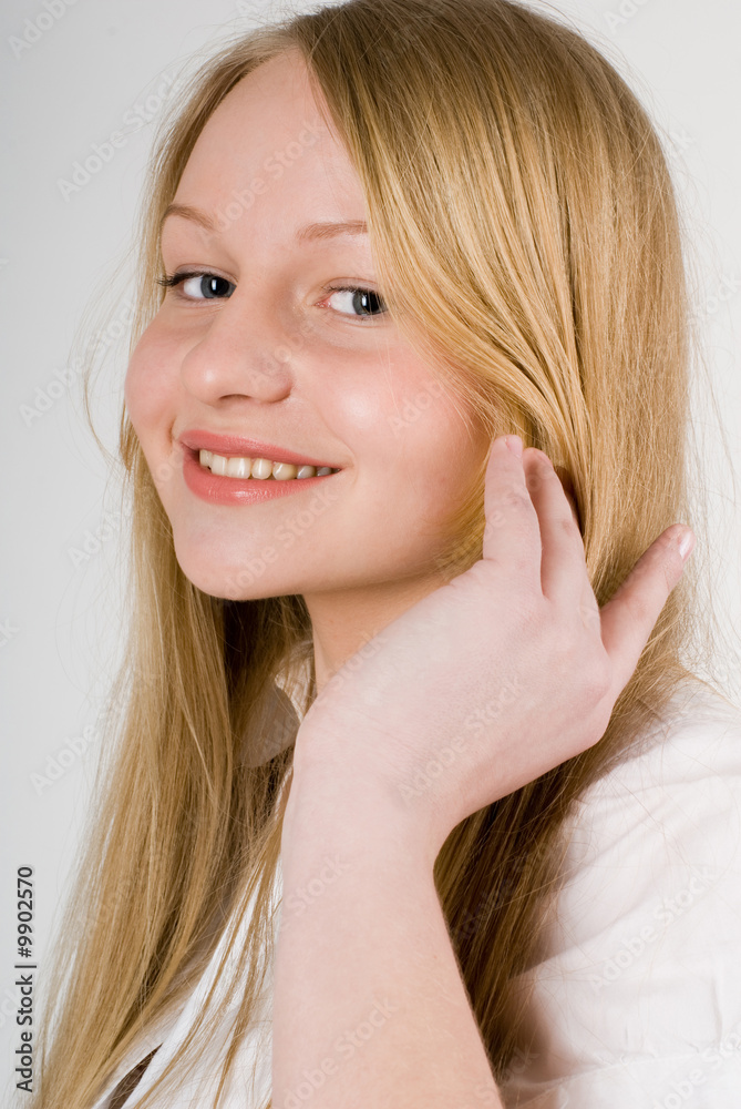 close-up of a young pretty long-haired smiling blond girl close-up of a young pretty long-haired smiling blond girl