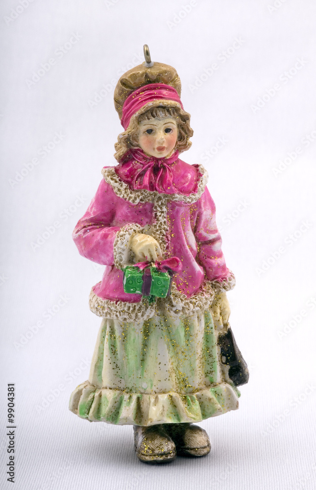 christmas doll, small statuette of the girl holding a gift. christmas doll, small statuette of the girl holding a gift.
