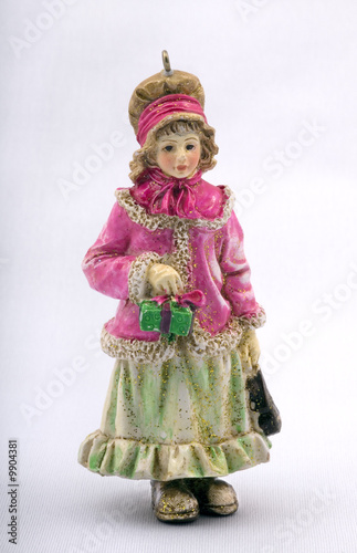 christmas doll, small statuette of the girl holding a gift.
