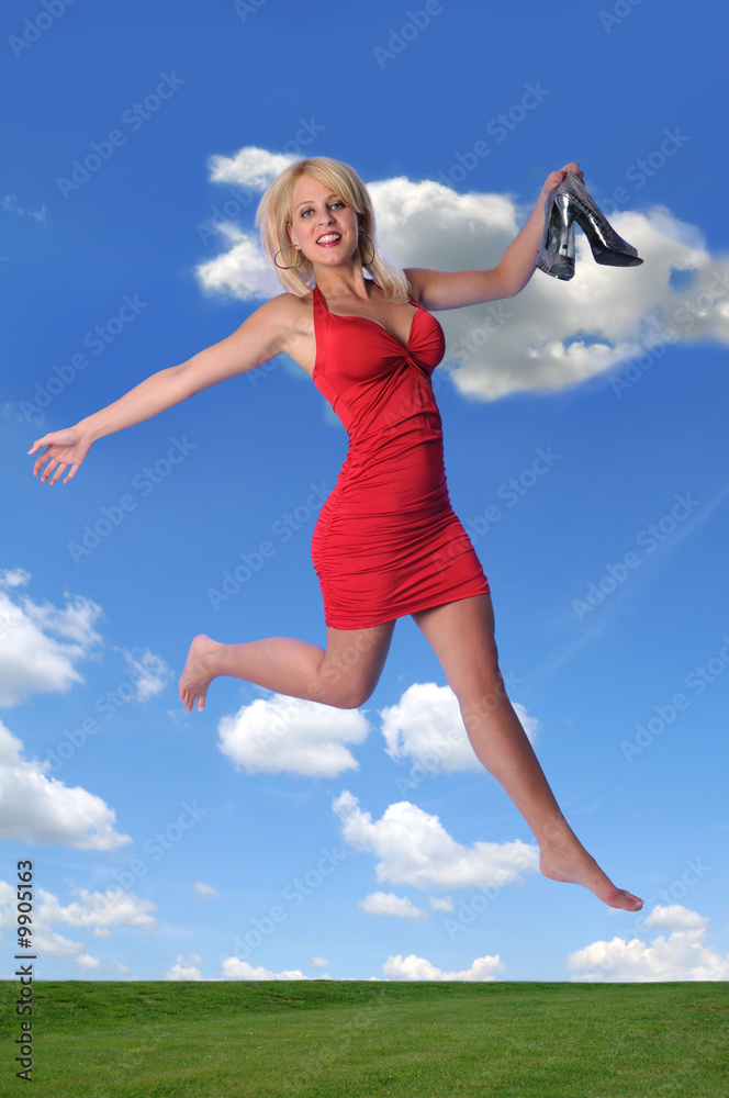 Young woman dressed in red jumping outdoors Young woman dressed in red jumping outdoors